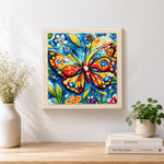 Finished intricate floral butterfly artwork displayed on a wall