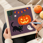 Creating handmade jack o lantern and cat punch needle artwork