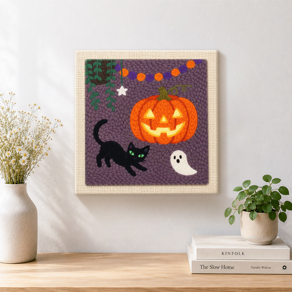 Finished jack o lantern and cat artwork displayed on a wall