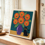 Jack‑o‑lantern blooms punch needle artwork displayed on a table