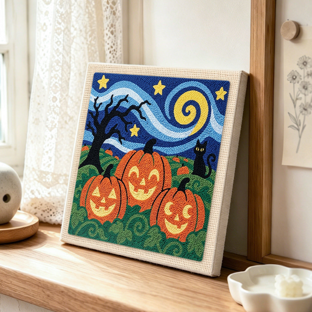 Jack‑o‑lantern field scene punch needle artwork displayed on a table