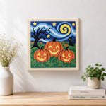 Finished jack‑o‑lantern field scene artwork displayed on a wall