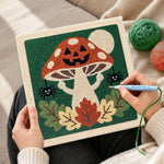 Creating handmade jack‑o‑lantern mushroom punch needle artwork