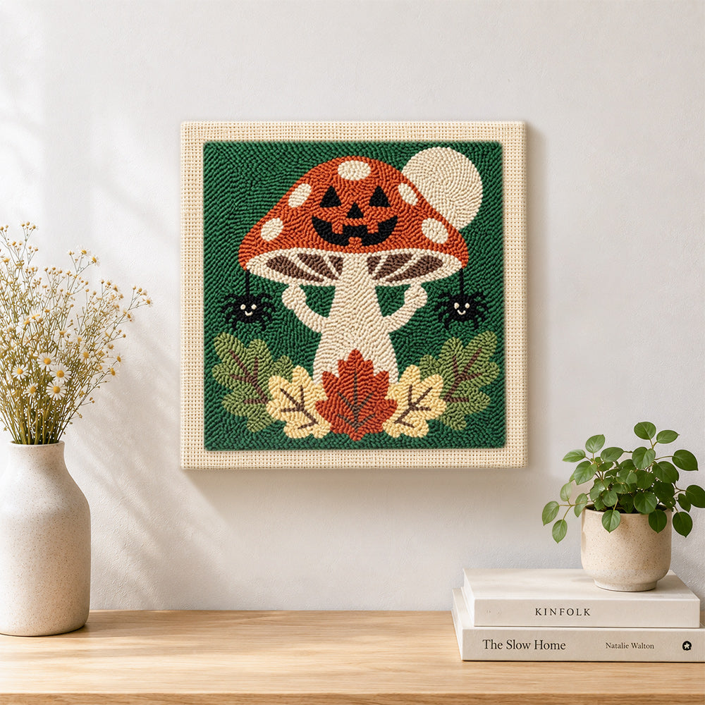 Finished jack‑o‑lantern mushroom artwork displayed on a wall