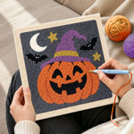 Creating handmade jack o lantern wearing witch hat punch needle artwork