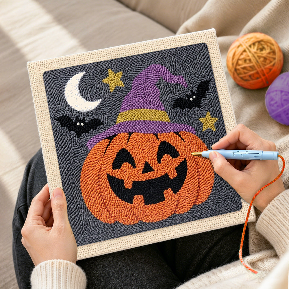 Creating handmade jack o lantern wearing witch hat punch needle artwork