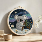 Koala and mountains under the stars punch needle artwork displayed on a table
