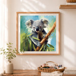 Finished koala on tree branch cross stitch artwork displayed as home decor