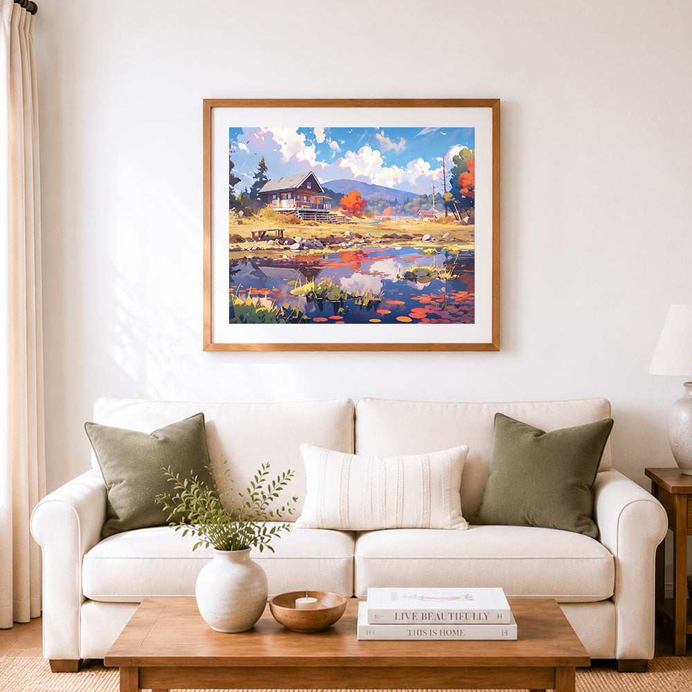 Finished lakeside cabin in autumn cross stitch artwork displayed as home decor