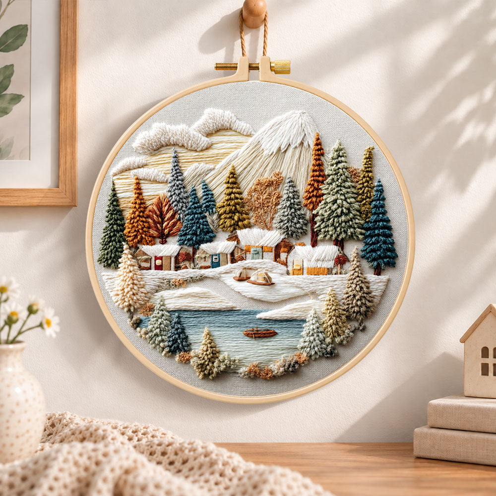 Lakeside snow town embroidery hoop wall art displayed as warm and cozy handmade home decor
