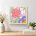 Finished large pink and purple flowers artwork displayed on a wall