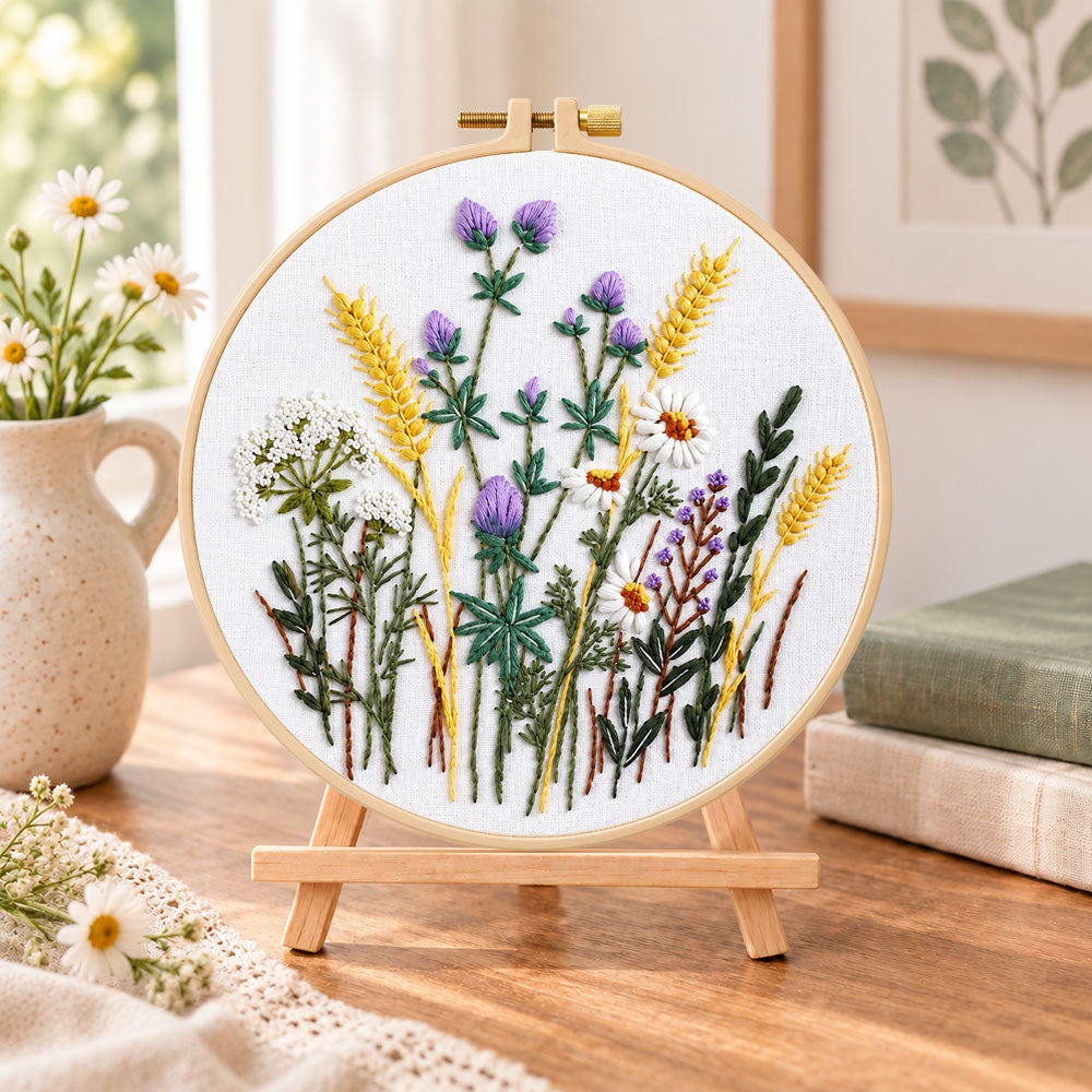 Lavender and wheat bouquet embroidery kit finished hoop displayed on a wooden stand as cozy tabletop decor