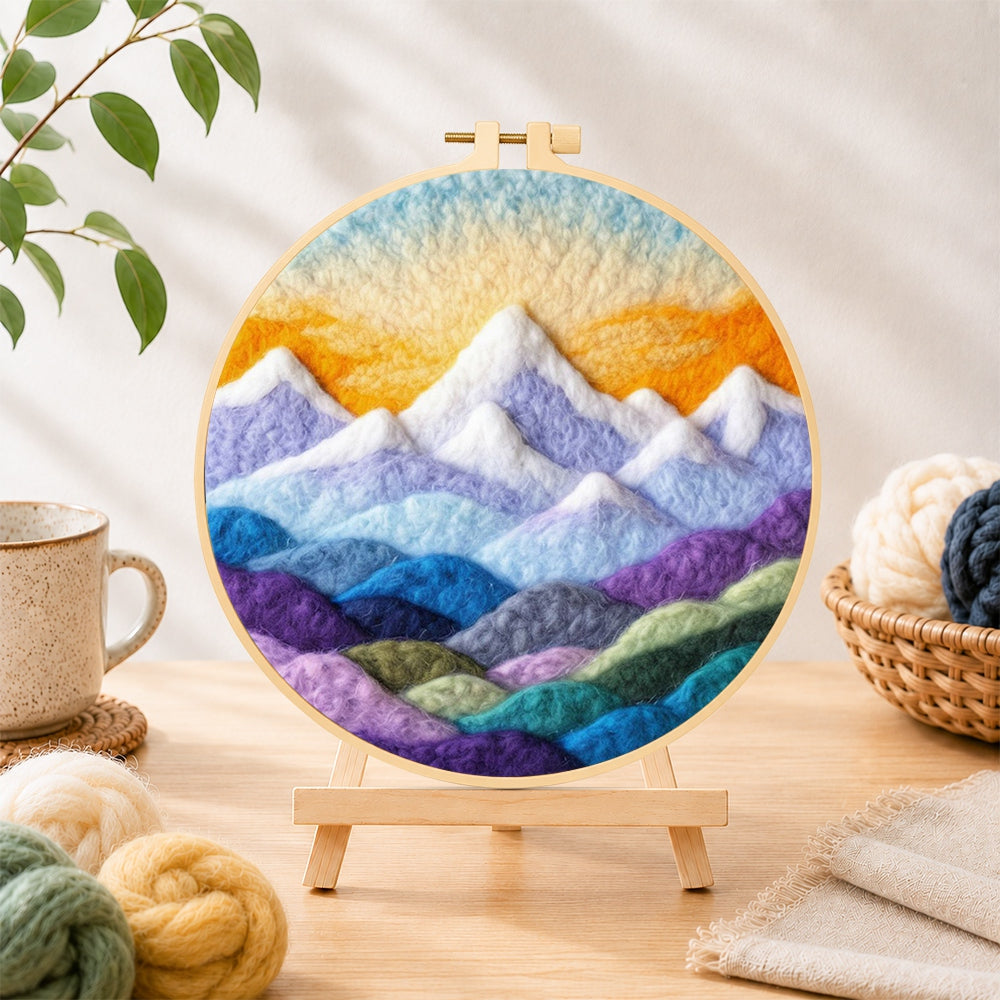 Finished layered colorful mountain peaks at sunrise needle felting displayed on a wooden easel
