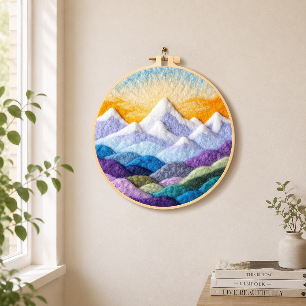 Layered colorful mountain peaks at sunrise needle felt wall art displayed in a bright home interior