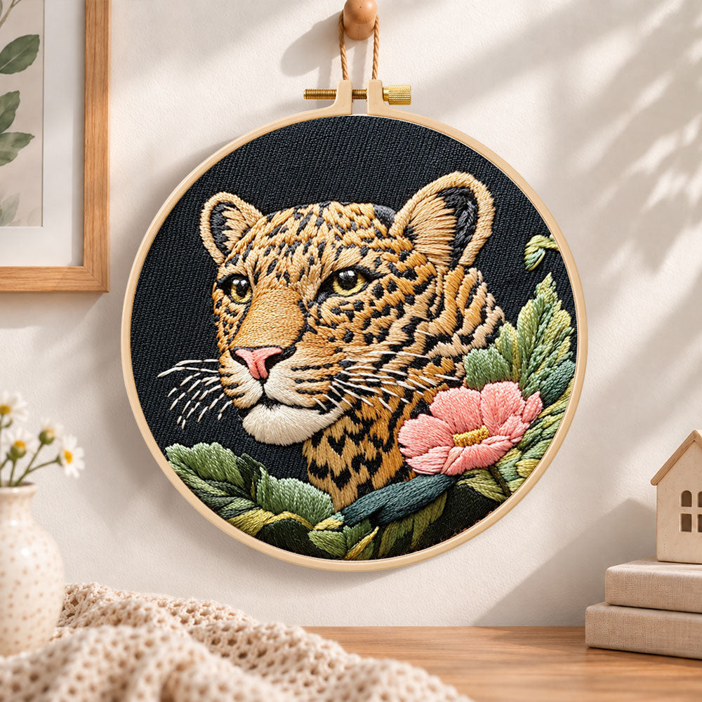 Leopard and pink wildflower embroidery hoop wall art displayed as warm and cozy handmade home decor