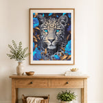 Finished leopard with blue blooms cross stitch artwork displayed as home decor