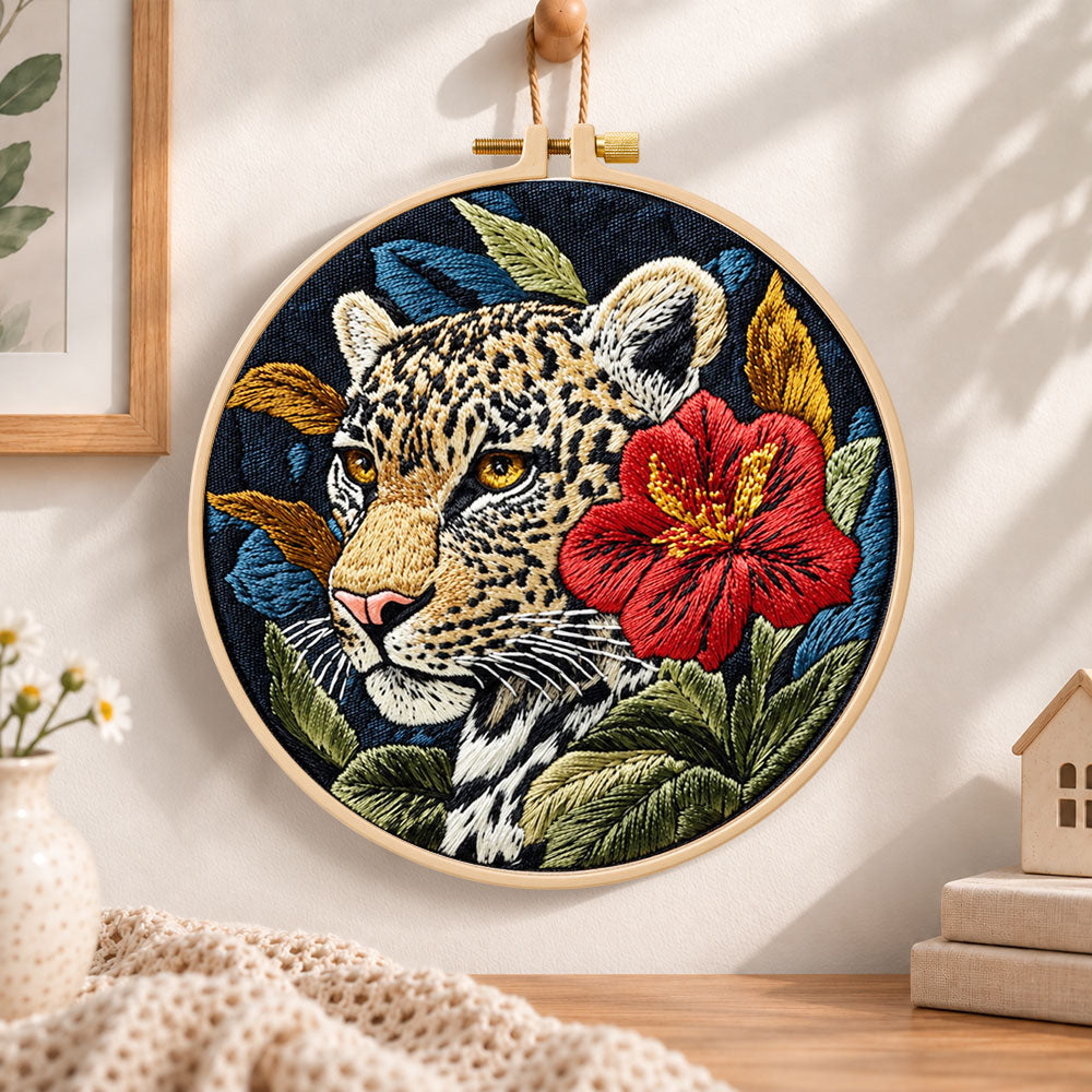 Leopard with red hibiscus embroidery hoop wall art displayed as warm and cozy handmade home decor