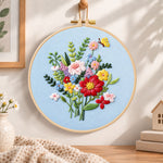 Light blue florals with butterfly embroidery hoop wall art displayed as warm and cozy handmade home decor