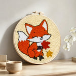 Little fox and maple leaves punch needle artwork displayed on a table