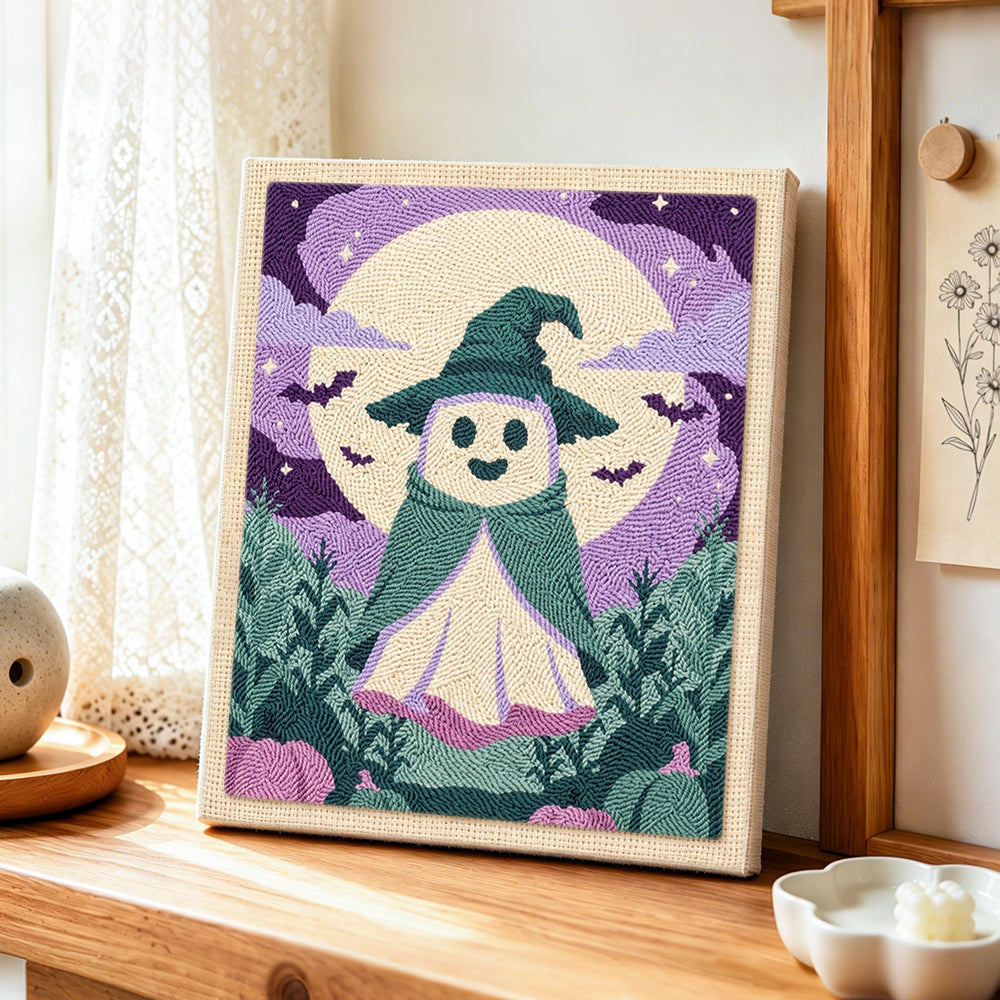 Little ghost witch under full moon punch needle artwork displayed on a table