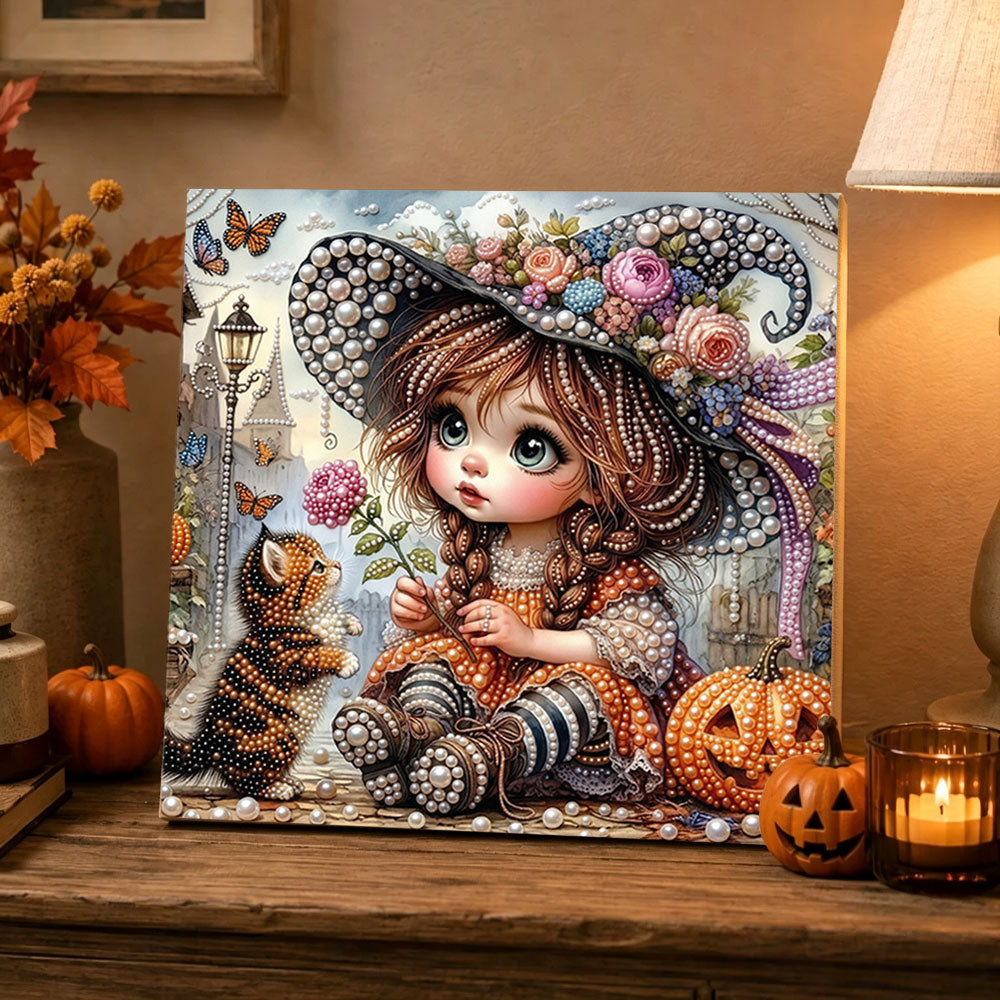 Finished little witch girl and kitten pearl diamond painting artwork displayed as holiday home decor