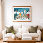 Finished lively snowy street with clock tower cross stitch artwork displayed as home decor
