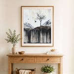 Finished lone tree over cliffs cross stitch artwork displayed as home decor