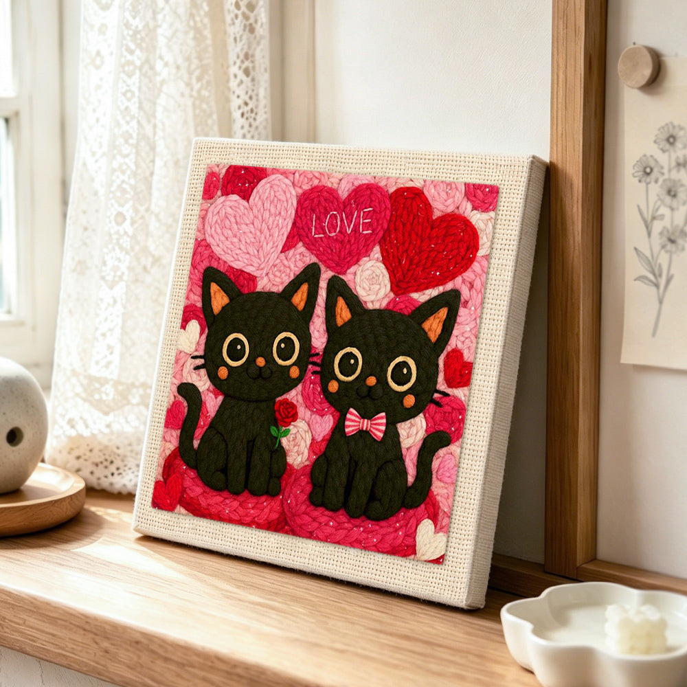"LOVE" black cat couple with rose punch needle artwork displayed on a table