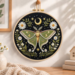 Luna moth and crescent moon embroidery hoop wall art displayed as warm and cozy handmade home decor