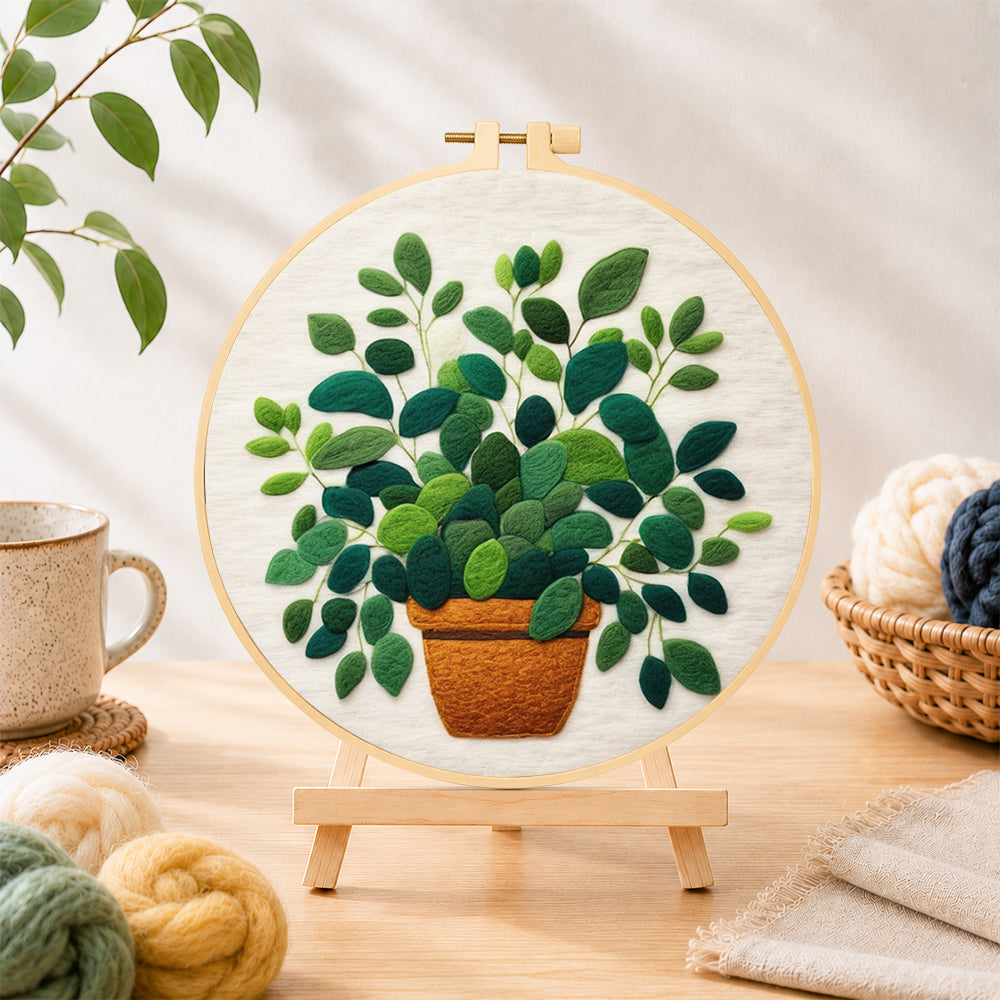 Finished lush green potted plant needle felting displayed on a wooden easel