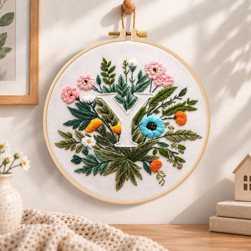 Lush greenery and letter y embroidery hoop wall art displayed as warm and cozy handmade home decor