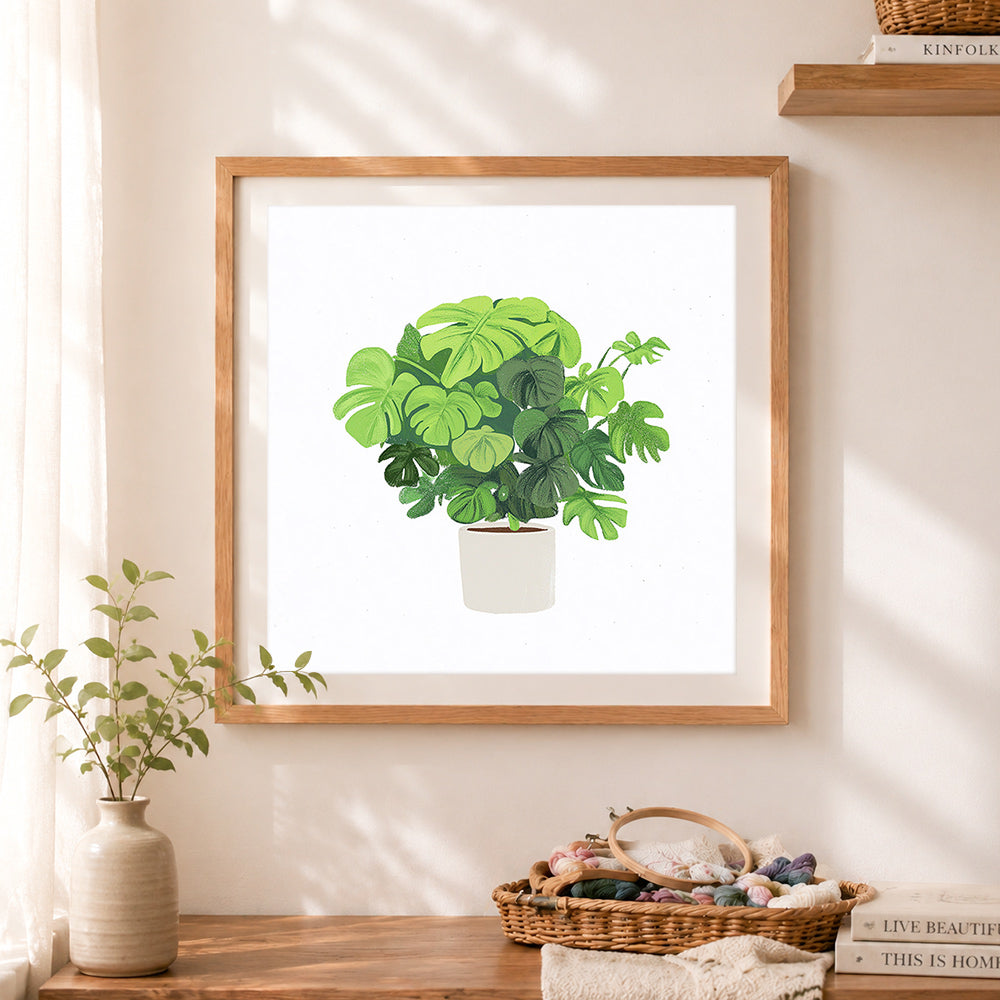 Finished lush monstera potted plant cross stitch artwork displayed as home decor