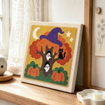Magic halloween tree with ghosts punch needle artwork displayed on a table