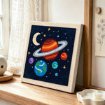 Magical and colorful solar system punch needle artwork displayed on a table
