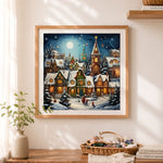 Finished magical winter town cross stitch artwork displayed as home decor