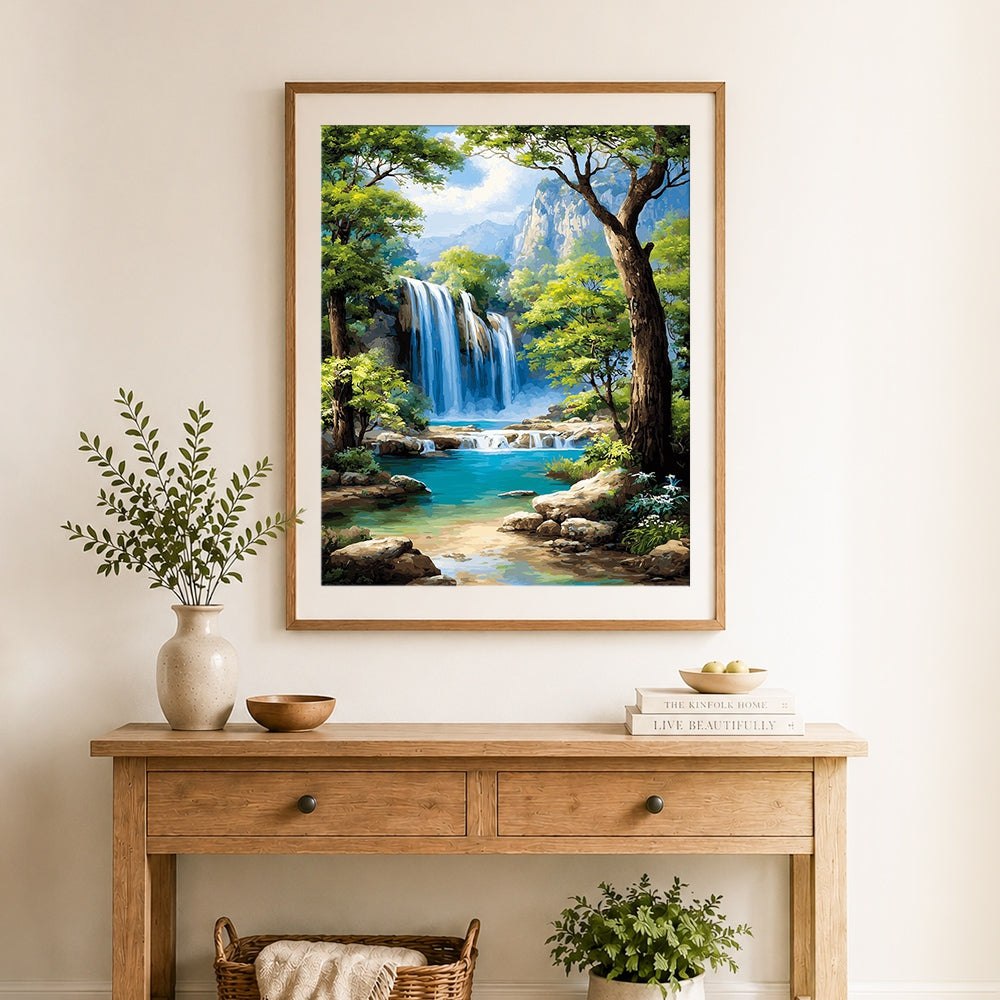 Finished majestic blue waterfall in forest canyon cross stitch artwork displayed as home decor