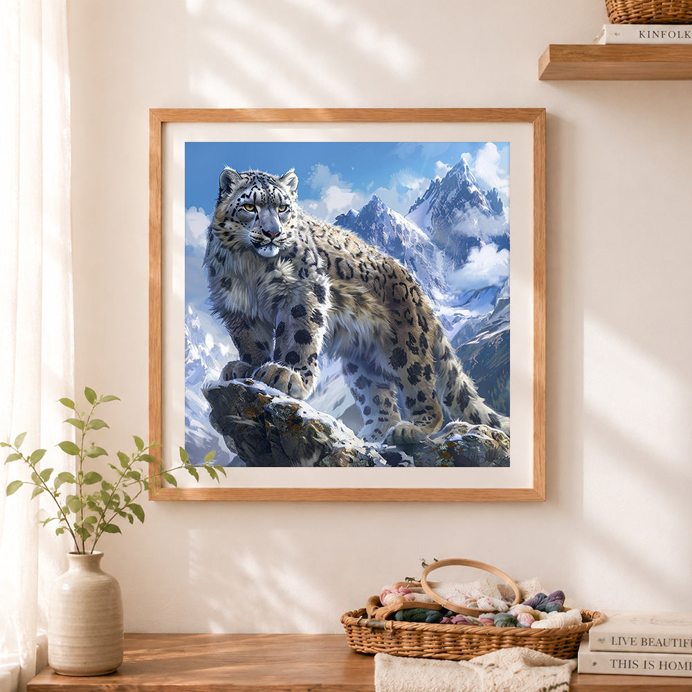 Finished majestic snow leopard on mountain peak cross stitch artwork displayed as home decor