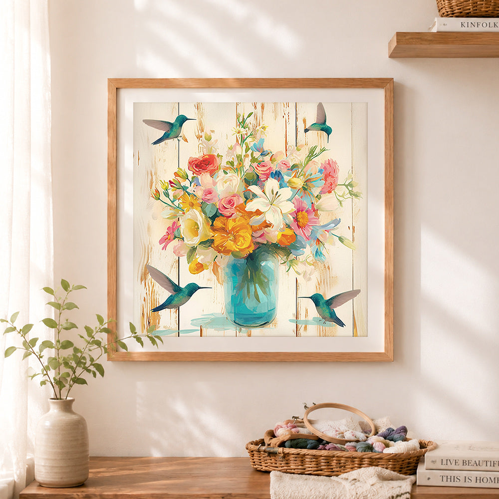 Finished mason jar flowers and hummingbirds cross stitch artwork displayed as home decor