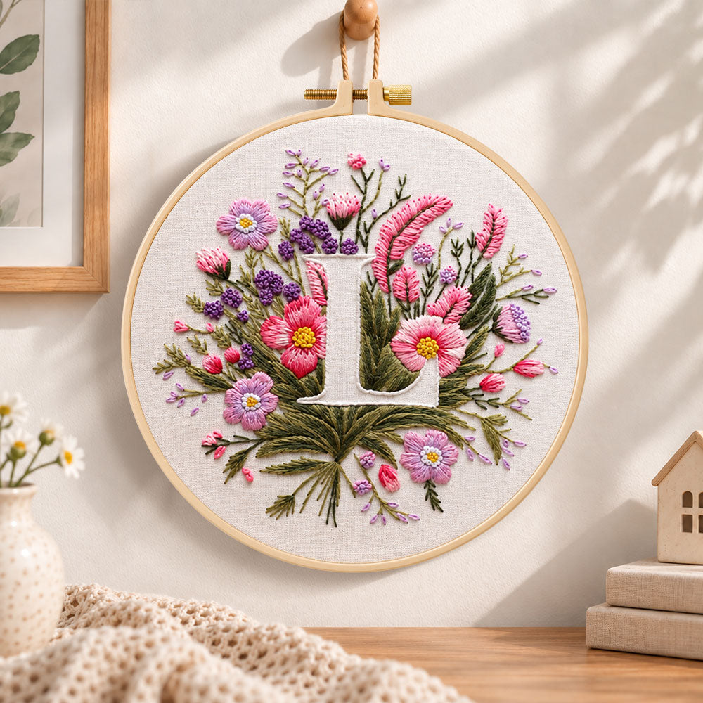 Mauve wildflowers and letter l embroidery hoop wall art displayed as warm and cozy handmade home decor