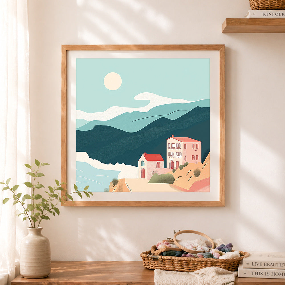 Finished mediterranean cliff town cross stitch artwork displayed as home decor