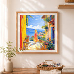 Finished mediterranean coastal terrace scene cross stitch artwork displayed as home decor