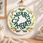 Merry christmas wreath embroidery hoop wall art displayed as warm and cozy handmade home decor