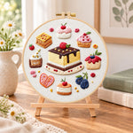 Mini dessert collection embroidery kit finished hoop displayed on a wooden stand as cozy tabletop decor