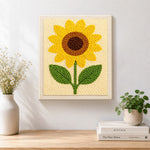 Finished minimalist sunflower artwork displayed on a wall