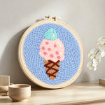 Mint and pink scoop ice cream punch needle artwork displayed on a table