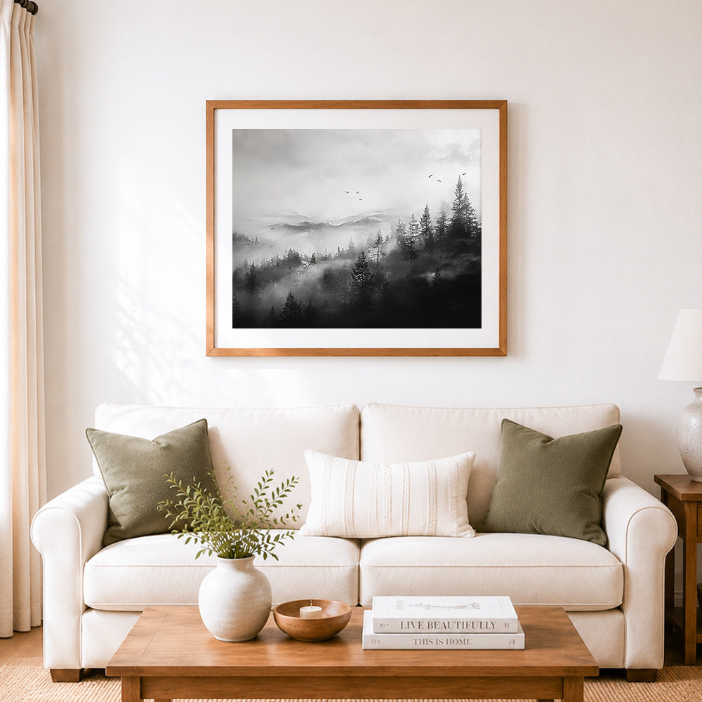 Finished misty mountain forest in black and white cross stitch artwork displayed as home decor