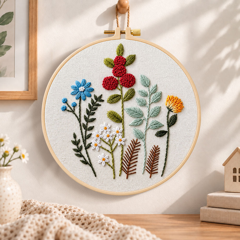 Mixed botanical floral embroidery hoop wall art displayed as warm and cozy handmade home decor