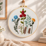Mixed botanical floral embroidery hoop wall art displayed as warm and cozy handmade home decor