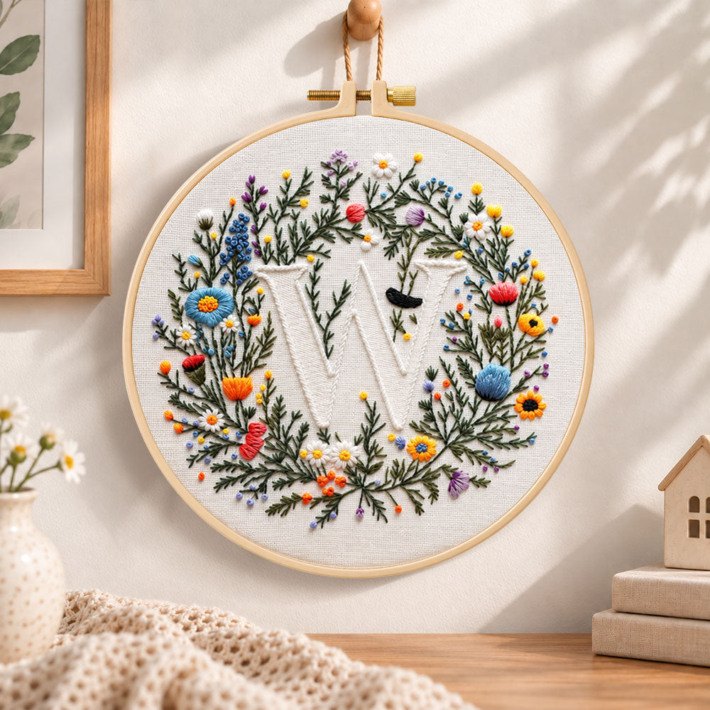 Mixed floral wreath and letter w embroidery hoop wall art displayed as warm and cozy handmade home decor