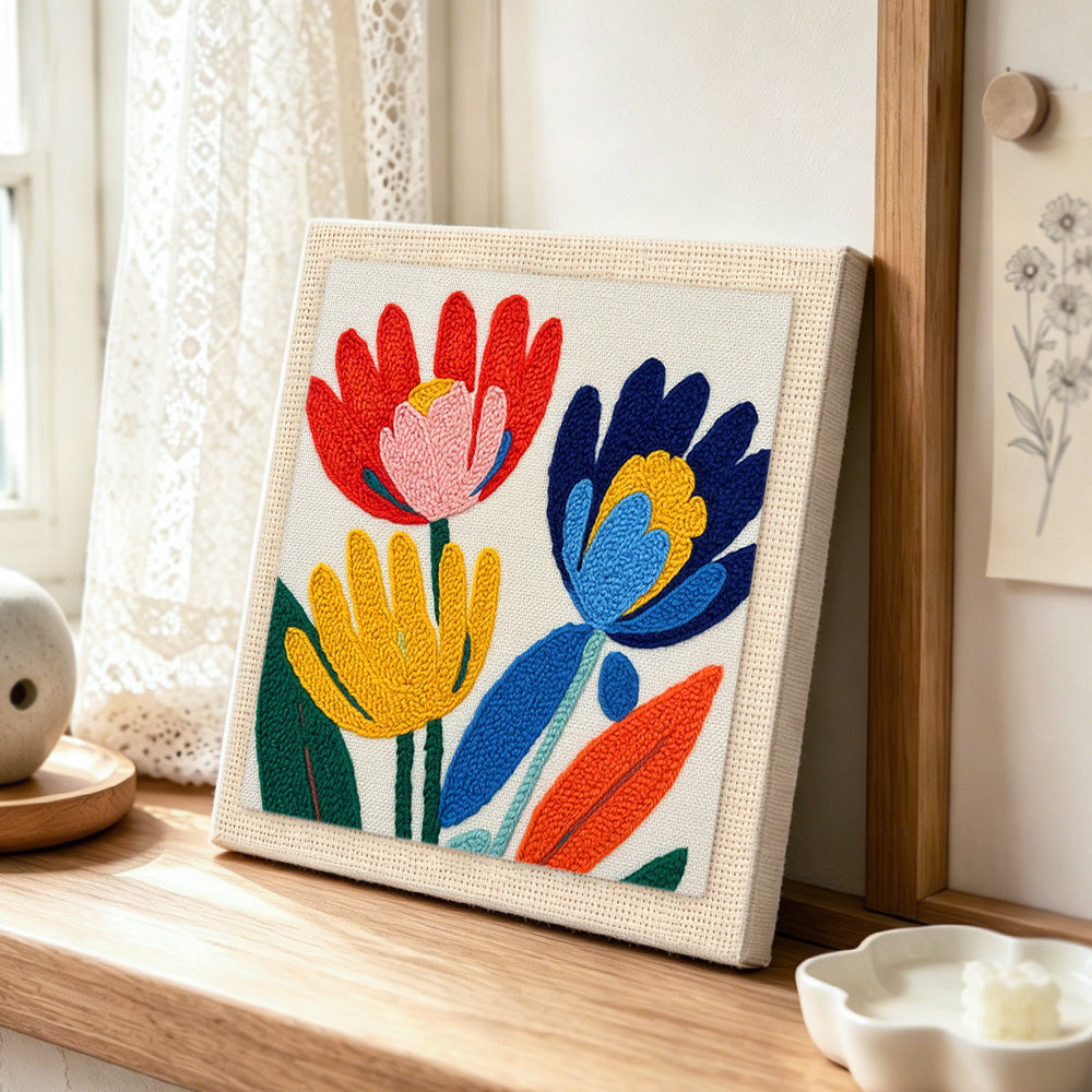 Modern abstract and colorful flowers punch needle artwork displayed on a table